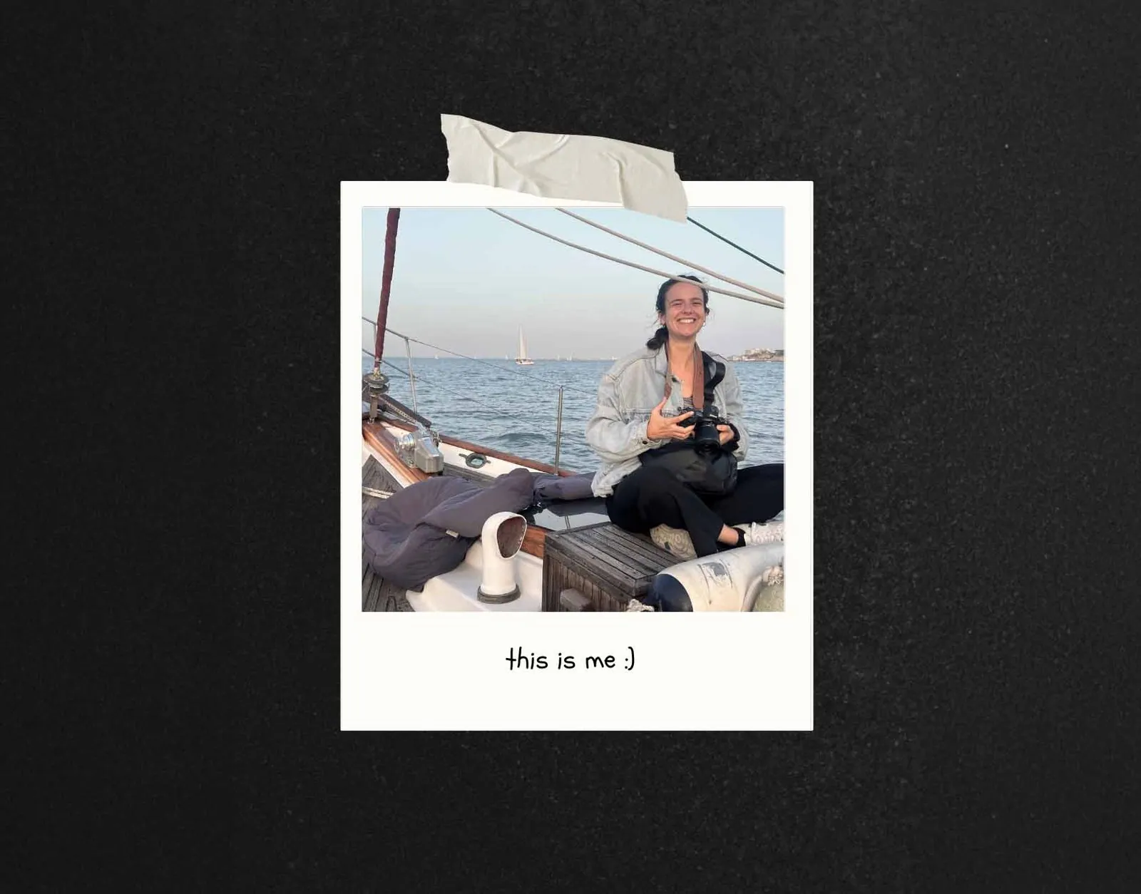 Wedding photographer smiling and holding a camera on a sailboat