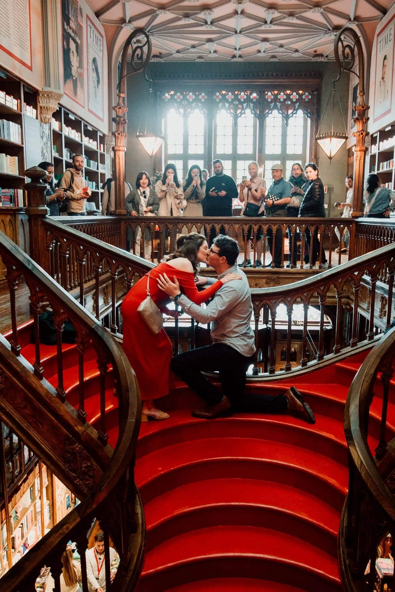 Marriage proposal on the iconic red staircase of Livraria Lello in Porto, Portugal