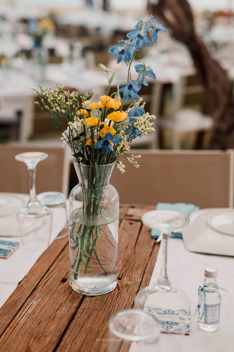Greek island beach wedding table details with blue tile invitation and Mediterranean aesthetic